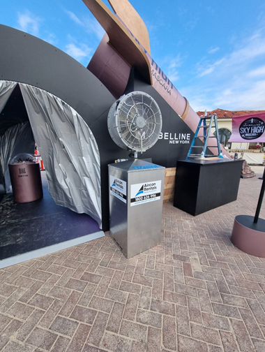 Industrial misting fan hire setup at outdoor event for cooling and comfort.